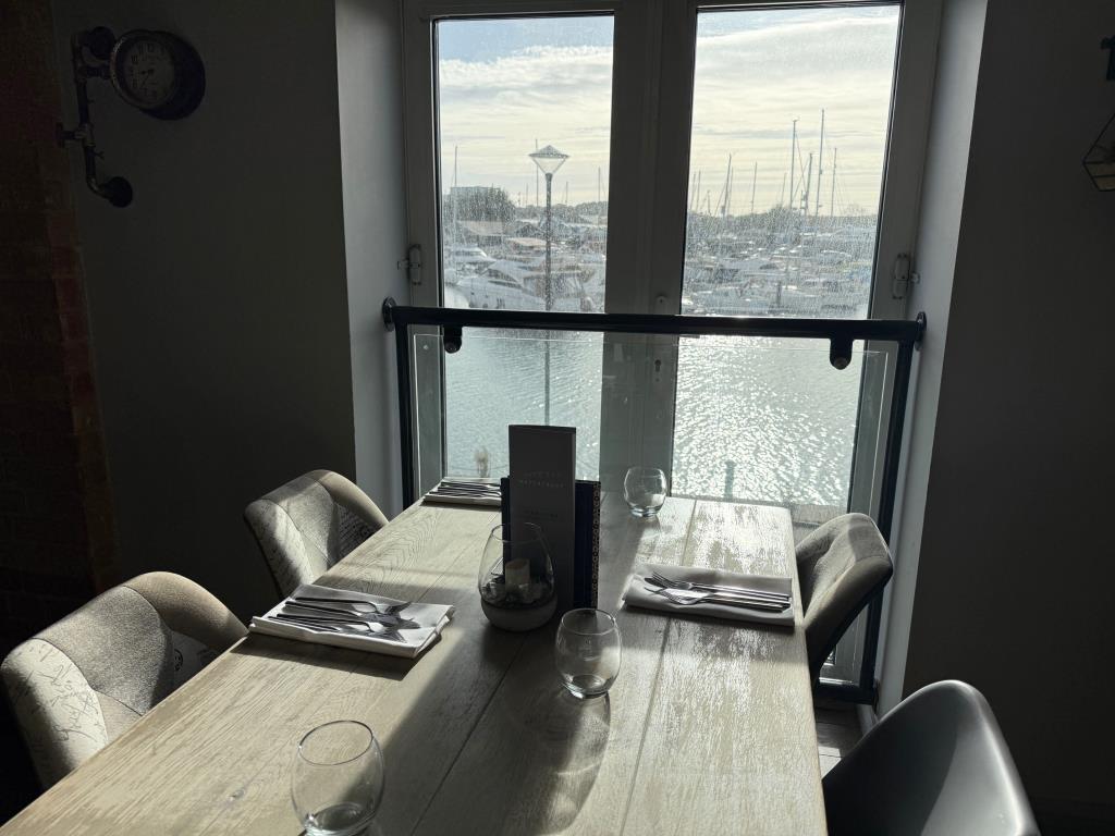 Lot: 70 - RESTAURANT IN MARINA LOCATION WITH POTENTIAL - First Floor Table in a view of the marina and boats